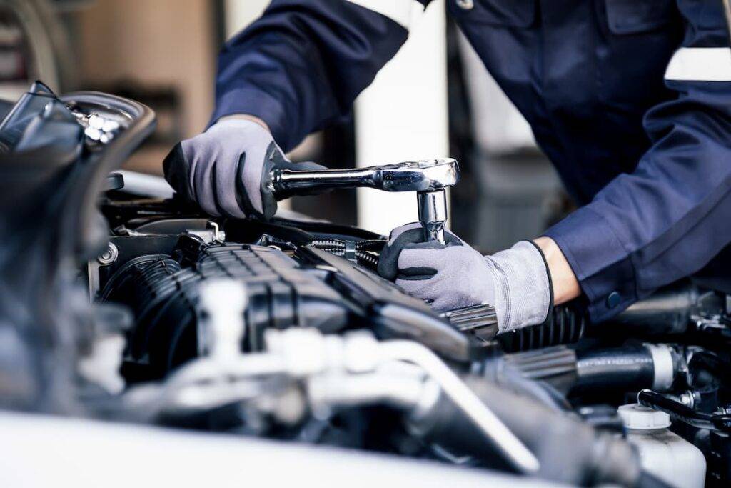 Mechanic fixing MOT repairs